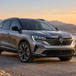Un Renault Austral hybride sur une route en fin de journée.